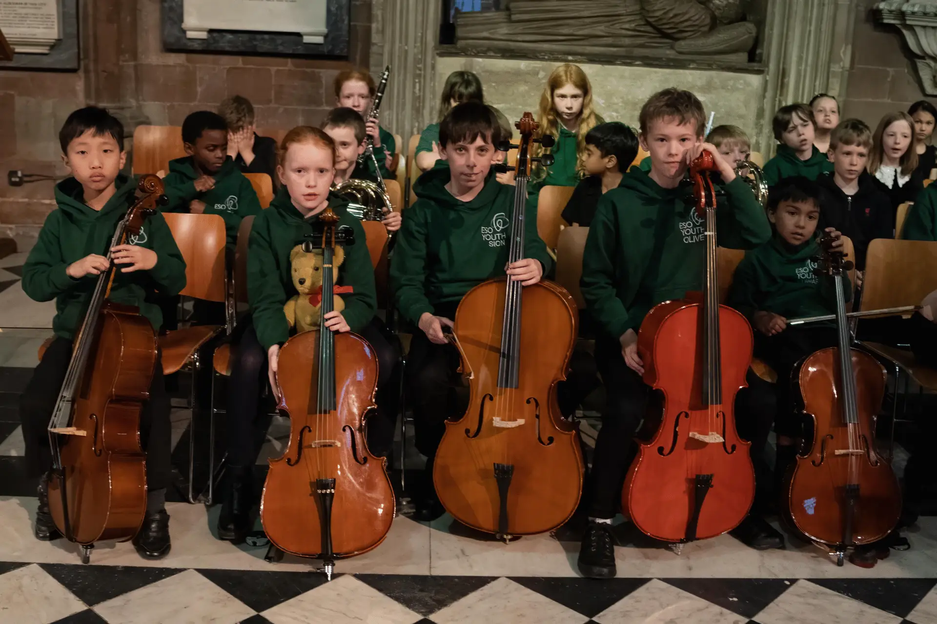 Group photo of the young musicians holding their instruments