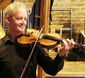 Paul Leinthall-Cowman smiling and playing the violin